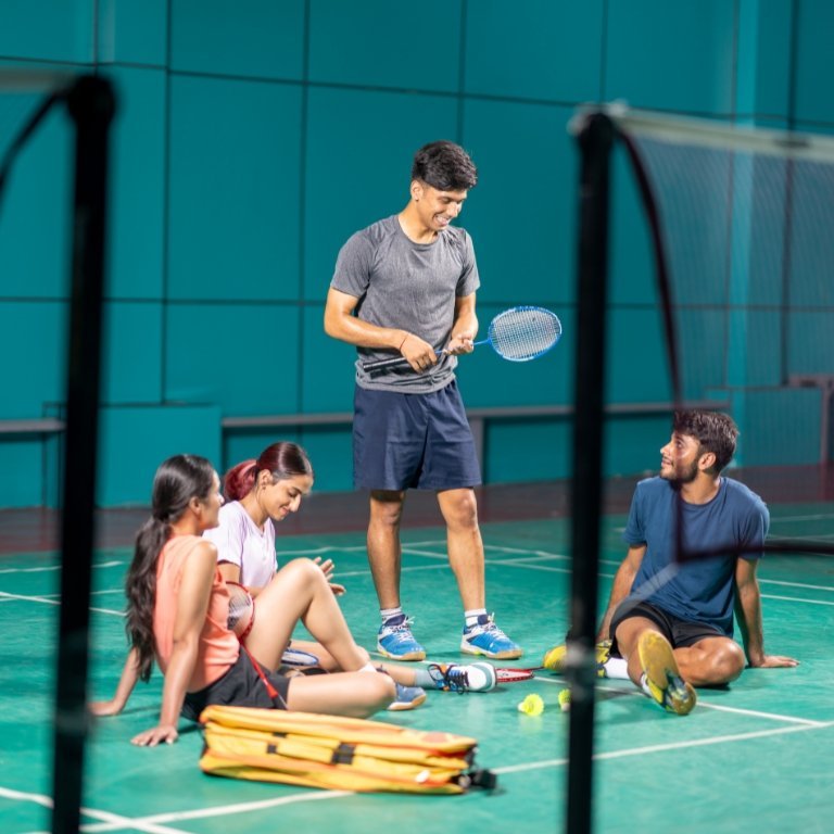 Athletes and badminton players on professional indoor wooden court
